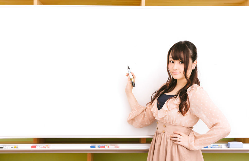 ホワイトボードを使って説明している女性